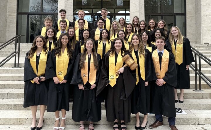 all mortar board members posing together on steps